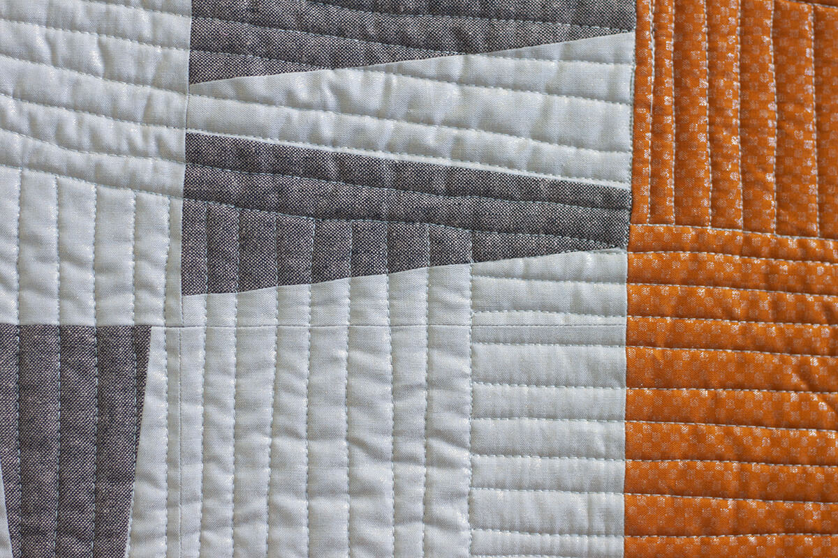 Slash quilt close up in languid fabrics by carolyn friedlander