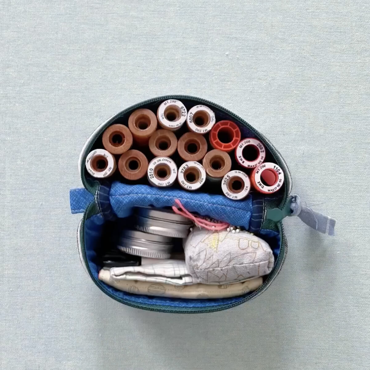 split pouch filled with sewing supplies